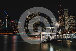 Glowing lights of city pier and skyscrapers