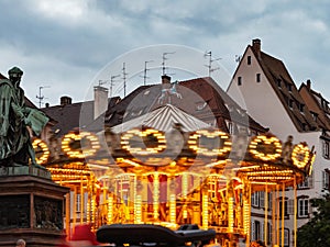 Glowing lights classic French carousel. Gutenberg Square in Strasbourg. Evening