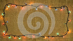 Glowing lights for Xmas Holiday, Garlands on sackcloth background