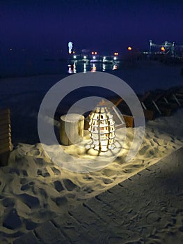 Glowing marine rope lamp on the beach at night