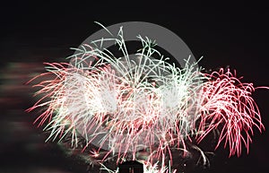 A glowing maze of fireworks with colours reflecting off the smoke and clouds.