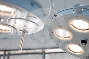 Glowing medical lamp on the ceiling in the operating room. Surgical lamp view from the bottom and from the side above