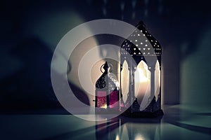 Glowing Moroccan ornamental lanterns on the table. Greeting card, invitation for Muslim holy month Ramadan Kareem