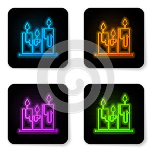 Glowing neon Burning candles icon isolated on white background. Cylindrical candle stick with burning flame. Black