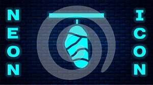 Glowing neon Butterfly cocoon icon isolated on brick wall background. Pupa of the butterfly. Vector