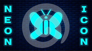 Glowing neon Butterfly icon isolated on brick wall background. Vector