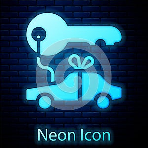 Glowing neon Car gift icon isolated on brick wall background. Car key prize. Vector