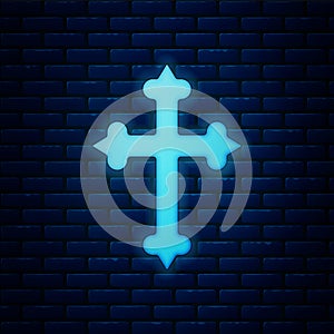 Glowing neon Christian cross icon isolated on brick wall background. Church cross. Vector