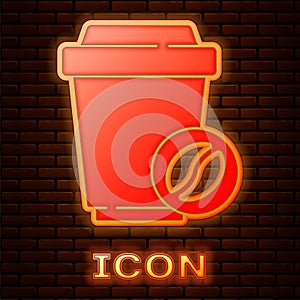 Glowing neon Coffee cup to go icon isolated on brick wall background. Vector