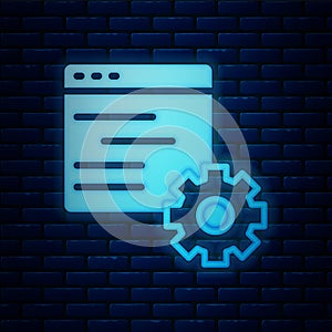 Glowing neon Computer api interface icon isolated on brick wall background. Application programming interface API