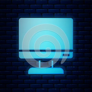Glowing neon Computer monitor screen icon isolated on brick wall background. Electronic device. Front view. Vector