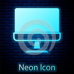 Glowing neon Computer monitor screen icon isolated on brick wall background. Electronic device. Front view. Vector