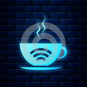 Glowing neon Cup of coffee shop with free wifi zone icon isolated on brick wall background. Internet connection placard