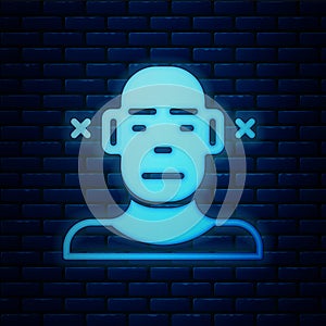 Glowing neon Deafness icon isolated on brick wall background. Deaf symbol. Hearing impairment. Vector