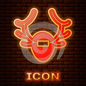 Glowing neon Deer antlers on shield icon isolated on brick wall background. Hunting trophy on wall. Vector