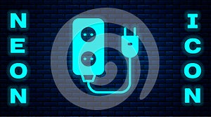 Glowing neon Electric extension cord icon isolated on brick wall background. Power plug socket. Vector