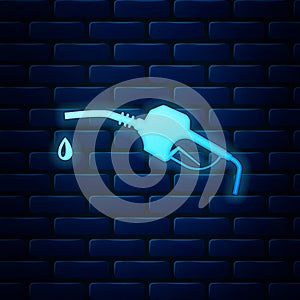 Glowing neon Gasoline pump nozzle icon isolated on brick wall background. Fuel pump petrol station. Refuel service sign