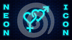 Glowing neon Gender icon isolated on brick wall background. Symbols of men and women. Sex symbol. Vector