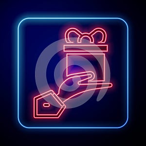 Glowing neon Give gift icon isolated on black background. Gift in hand. The concept of giving and receiving a gift