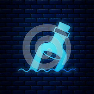 Glowing neon Glass bottle with a message in water icon isolated on brick wall background. Letter in the bottle. Pirates