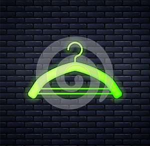 Glowing neon Hanger wardrobe icon isolated on brick wall background. Cloakroom icon. Clothes service symbol. Laundry