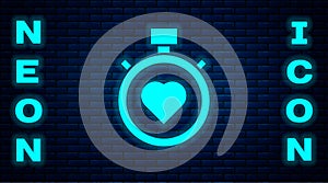 Glowing neon Heart in the center stopwatch icon isolated on brick wall background. Valentines day. Vector
