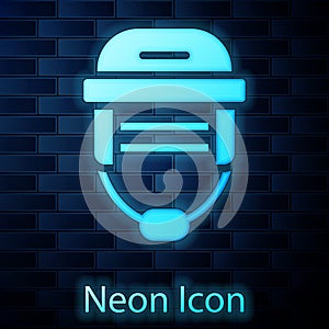 Glowing neon Hockey helmet icon isolated on brick wall background. Vector