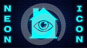 Glowing neon House with eye scan icon isolated on brick wall background. Scanning eye. Security check symbol. Cyber eye