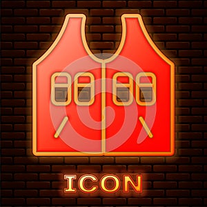 Glowing neon Hunting jacket icon isolated on brick wall background. Hunting vest. Vector