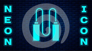 Glowing neon Jump rope icon isolated on brick wall background. Skipping rope. Sport equipment. Vector Illustration