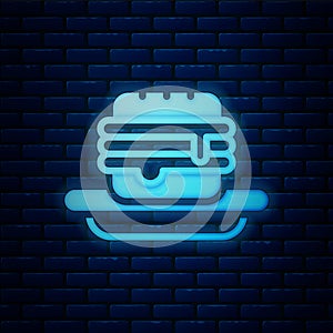 Glowing neon Junk food icon isolated on brick wall background. Prohibited hot dog. No Fast food sign. Vector