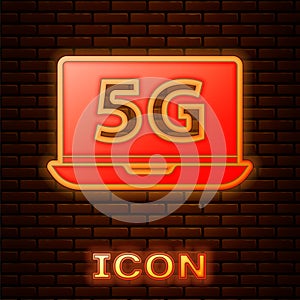 Glowing neon Laptop with 5G new wireless internet wifi icon isolated on brick wall background. Global network high speed