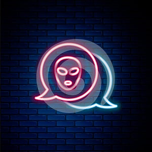 Glowing neon line Alien icon isolated on brick wall background. Extraterrestrial alien face or head symbol. Colorful