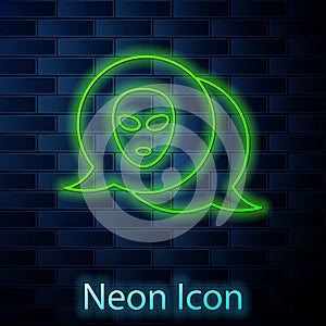 Glowing neon line Alien icon isolated on brick wall background. Extraterrestrial alien face or head symbol. Vector