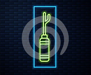 Glowing neon line Awl tool with wooden handle icon isolated on brick wall background. Work equipment tailor industry