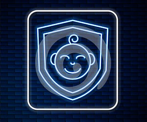 Glowing neon line Baby on shield icon isolated on brick wall background. Child safety sign. Vector