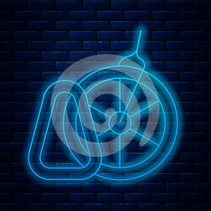 Glowing neon line Bicycle parking icon isolated on brick wall background. Vector