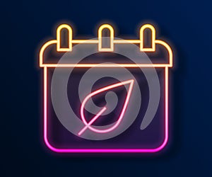 Glowing neon line Calendar with autumn leaves icon isolated on black background. Vector