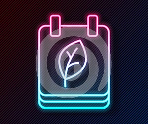 Glowing neon line Calendar with autumn leaves icon isolated on black background. Vector