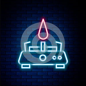 Glowing neon line Camping gas stove icon isolated on brick wall background. Portable gas burner. Hiking, camping