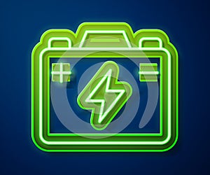 Glowing neon line Car battery icon isolated on blue background. Accumulator battery energy power and electricity