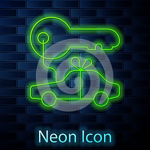 Glowing neon line Car gift icon isolated on brick wall background. Car key prize. Vector