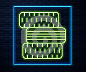 Glowing neon line Car tire wheel icon isolated on brick wall background. Vector Illustration