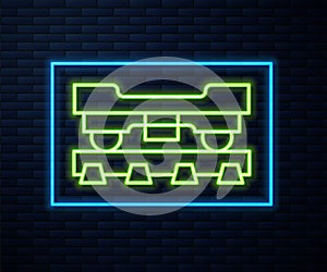 Glowing neon line Cargo train wagon icon isolated on brick wall background. Freight car. Railroad transportation. Vector