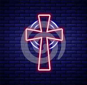Glowing neon line Celtic cross icon isolated on brick wall background. Happy Saint Patricks day. National Irish holiday