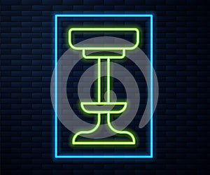 Glowing neon line Chair icon isolated on brick wall background. Vector