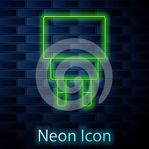 Glowing neon line Charger icon isolated on brick wall background. Vector