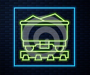 Glowing neon line Coal train wagon icon isolated on brick wall background. Rail transportation. Vector