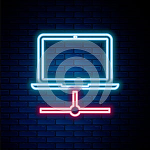Glowing neon line Computer network icon isolated on brick wall background. Laptop network. Internet connection. Colorful