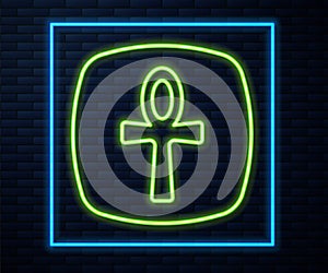 Glowing neon line Cross ankh icon isolated on brick wall background. Egyptian word for life or symbol of immortality